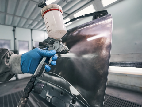 person-covering-car-with-protective-coating-463×348